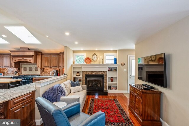 240 Meadow Dr, Haddonfield, NJ 08033 - living room with a skylight, light wood finished floors, a fireplace, and recessed lighting
