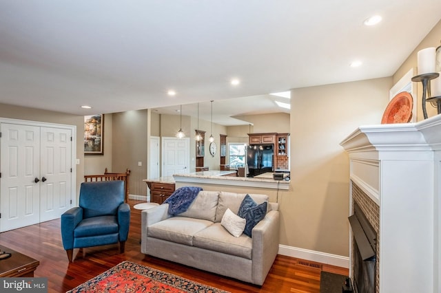 240 Meadow Dr, Haddonfield, NJ 08033 - living area with wood finished floors, a fireplace with flush hearth, and recessed lighting