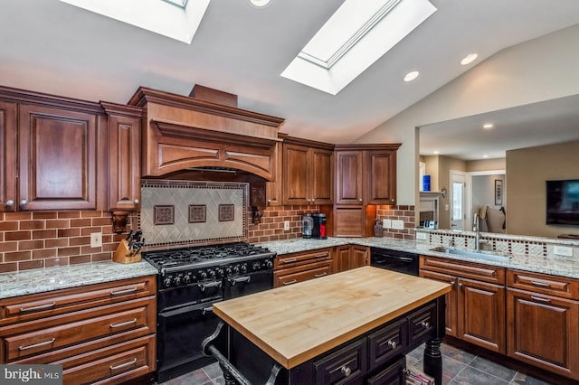 240 Meadow Dr, Haddonfield, NJ 08033 - kitchen with a skylight, butcher block counters, black appliances, vaulted ceiling, and recessed lighting