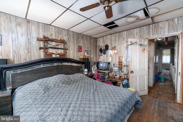 2560 W Fairmount Ave, Baltimore, MD 21223 - bedroom featuring wood walls, a paneled ceiling, and hardwood / wood-style flooring