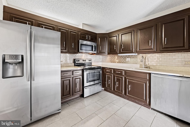 4100 N Charles St N Unit 803, Baltimore, MD 21218 - kitchen with appliances with stainless steel finishes, light countertops, dark brown cabinetry, backsplash, and a textured ceiling