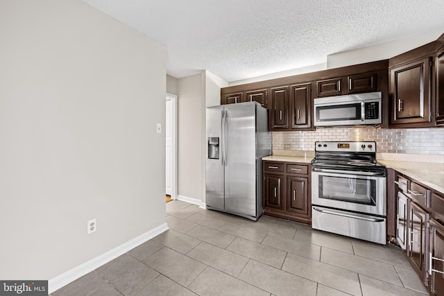 4100 N Charles St N Unit 803, Baltimore, MD 21218 - kitchen featuring stainless steel appliances, light countertops, decorative backsplash, dark brown cabinetry, and a textured ceiling