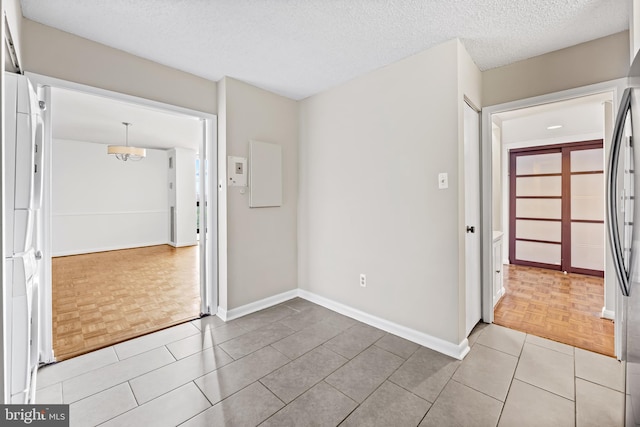 4100 N Charles St N Unit 803, Baltimore, MD 21218 - spare room featuring baseboards and a textured ceiling