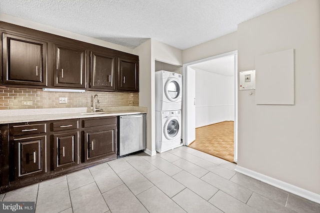 4100 N Charles St N Unit 803, Baltimore, MD 21218 - laundry room featuring estacked washer and dryer, a textured ceiling, and light tile patterned floors
