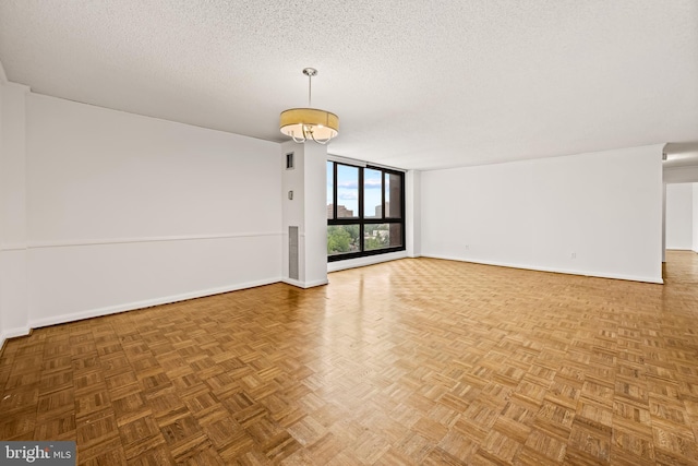 4100 N Charles St N Unit 803, Baltimore, MD 21218 - spare room featuring a textured ceiling and a wall of windows