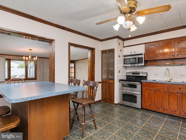 715 Griffith Rd, Glen Burnie, MD 21061 - kitchen featuring appliances with stainless steel finishes, a breakfast bar area, tasteful backsplash, ceiling fan, and crown molding