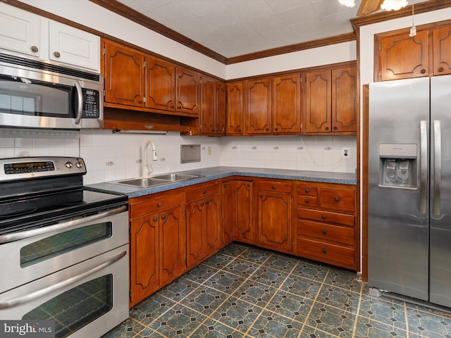 715 Griffith Rd, Glen Burnie, MD 21061 - kitchen featuring appliances with stainless steel finishes, crown molding, backsplash, brown cabinetry, and dark countertops