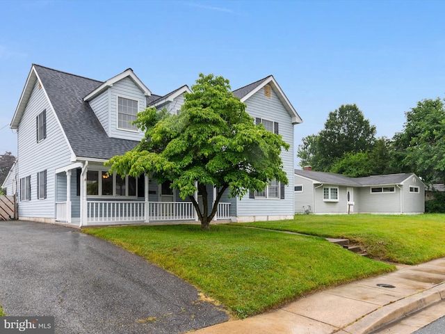 715 Griffith Rd, Glen Burnie, MD 21061 - view of front of house featuring a front yard, a shingled roof, and covered porch