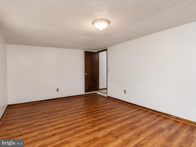 715 Griffith Rd, Glen Burnie, MD 21061 - empty room with wood finished floors and a textured ceiling