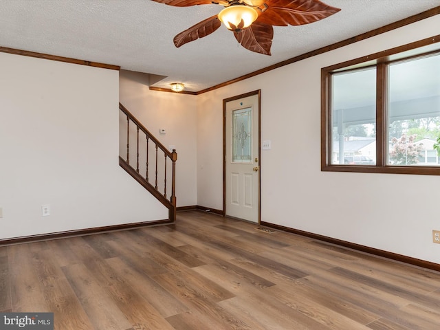 715 Griffith Rd, Glen Burnie, MD 21061 - entryway with a ceiling fan, crown molding, wood finished floors, stairway, and a textured ceiling