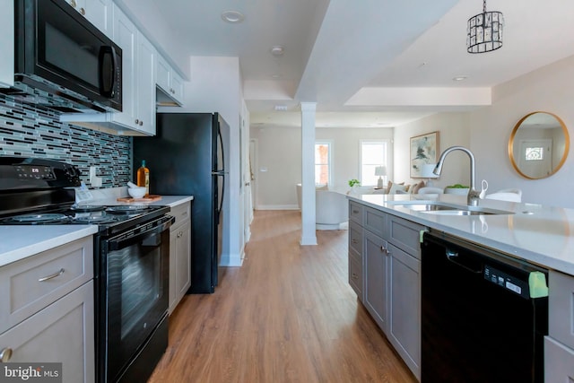1616 C St NE, Washington, DC 20002 - kitchen featuring black appliances, light countertops, tasteful backsplash, light wood-type flooring, and gray cabinets