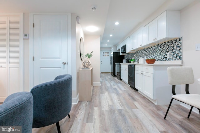 1616 C St NE, Washington, DC 20002 - kitchen featuring white cabinetry, light wood-style flooring, decorative backsplash, light countertops, and recessed lighting