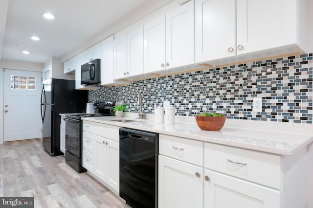 1616 C St NE, Washington, DC 20002 - kitchen featuring black appliances, tasteful backsplash, white cabinets, recessed lighting, and light wood finished floors