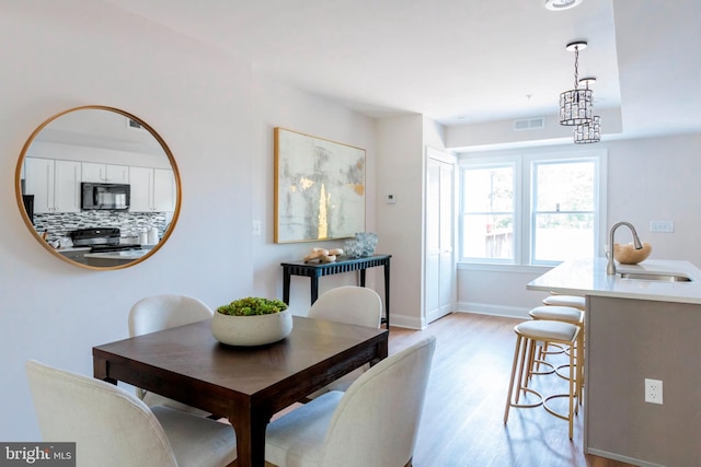 1616 C St NE, Washington, DC 20002 - dining room with light wood-style floors and a chandelier