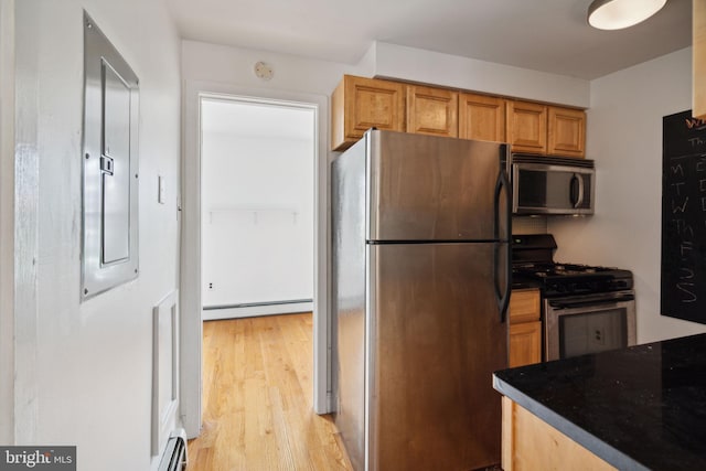 2016 Christian St Unit C, Philadelphia, PA 19146 - kitchen with appliances with stainless steel finishes, a baseboard heating unit, light wood-style floors, electric panel, and brown cabinets