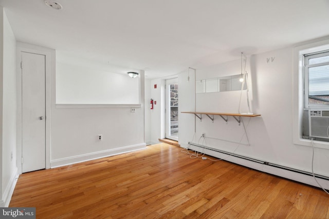 2016 Christian St Unit C, Philadelphia, PA 19146 - empty room with a baseboard heating unit, wood finished floors, and a smoke detector