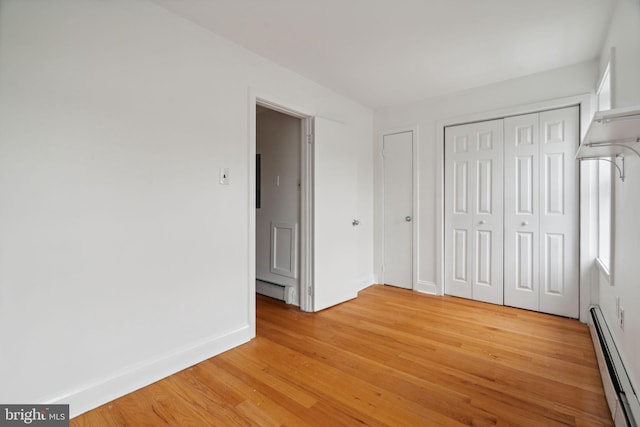 2016 Christian St Unit C, Philadelphia, PA 19146 - unfurnished bedroom featuring baseboard heating, light wood finished floors, and a closet