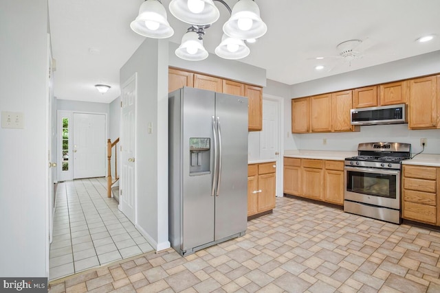 6483 Sedgwick St, Elkridge, MD 21075 - kitchen with stainless steel appliances, light countertops, pendant lighting, and a chandelier