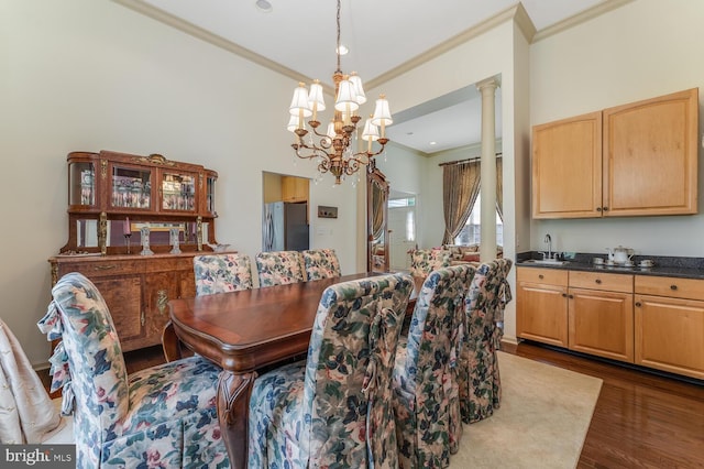7 Colts Ln, Flemington, NJ 08822 - dining area featuring ornamental molding, dark wood-style floors, a chandelier, and ornate columns