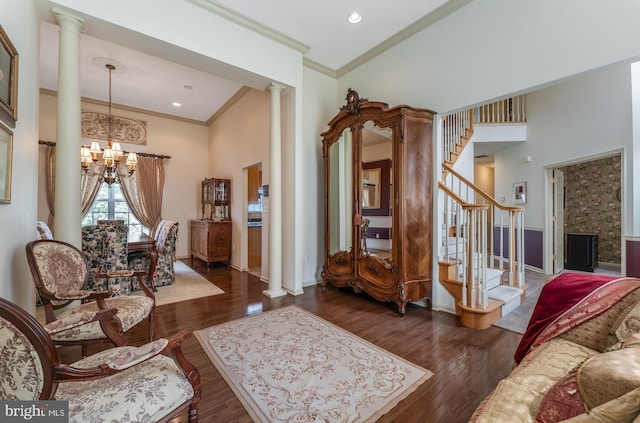 7 Colts Ln, Flemington, NJ 08822 - living area featuring decorative columns, a chandelier, crown molding, stairs, and wood finished floors