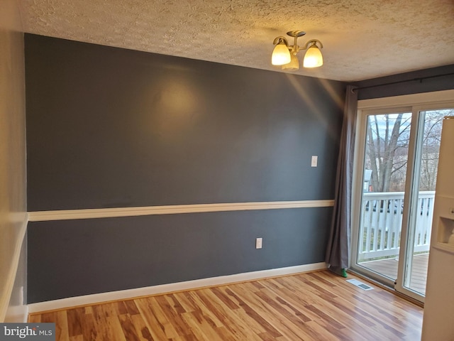 505 Northview Rd, Mount Airy, MD 21771 - spare room featuring a chandelier, wood finished floors, and a textured ceiling