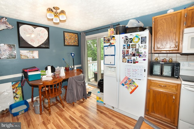 505 Northview Rd, Mount Airy, MD 21771 - kitchen with white appliances, light wood-style floors, brown cabinetry, light countertops, and a textured ceiling