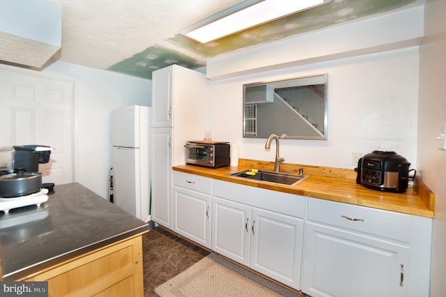 505 Northview Rd, Mount Airy, MD 21771 - kitchen with freestanding refrigerator, white cabinets, and wooden counters