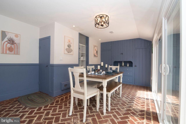 716 Old Fallston Rd, Fallston, MD 21047 - dining space with brick flooring, wainscoting, lofted ceiling, a chandelier, and wood walls