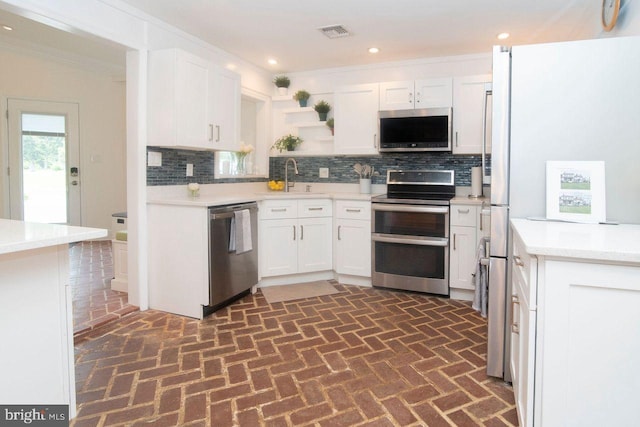 716 Old Fallston Rd, Fallston, MD 21047 - kitchen with stainless steel appliances, brick flooring, tasteful backsplash, ornamental molding, and recessed lighting
