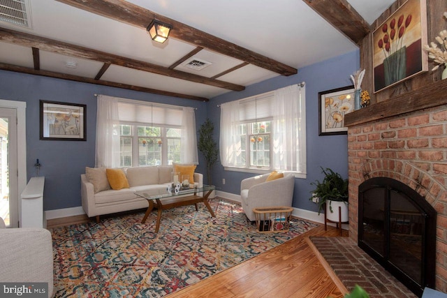 716 Old Fallston Rd, Fallston, MD 21047 - living room featuring wood finished floors, beam ceiling, and a brick fireplace