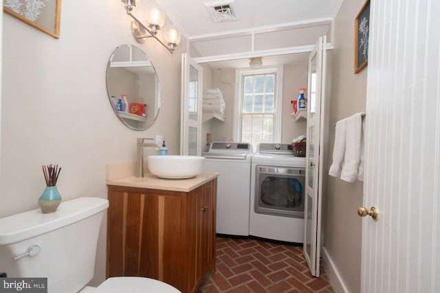 716 Old Fallston Rd, Fallston, MD 21047 - bathroom featuring washer and dryer, brick flooring, and vanity