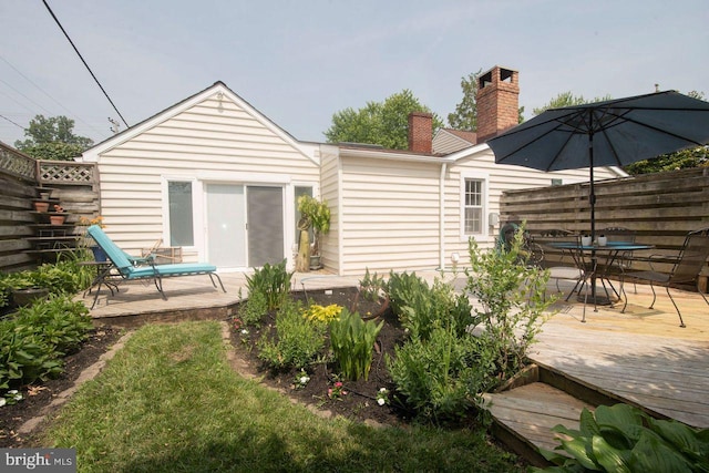 716 Old Fallston Rd, Fallston, MD 21047 - back of property featuring a deck, outdoor dining space, and a chimney