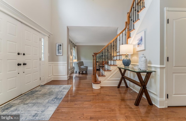 96 Becks Blvd, Ringoes, NJ 08551 - foyer entrance with a decorative wall, stairs, wood finished floors, a wainscoted wall, and a towering ceiling