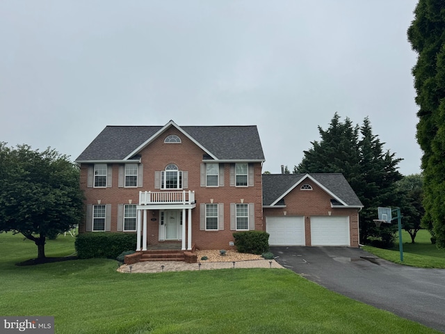 17258 Hardy Rd, Mount Airy, MD 21771 - georgian-style home featuring driveway, brick siding, an attached garage, a front lawn, and a shingled roof