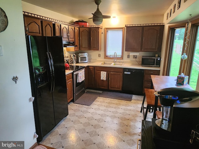 27 Gladys Trl, Fairfield, PA 17320 - kitchen featuring black appliances, range hood, light floors, light countertops, and dark brown cabinetry