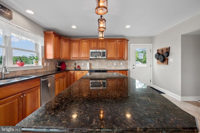 694 Ridge Rd, Telford, PA 18969 - kitchen with stainless steel appliances, backsplash, brown cabinets, dark stone countertops, and recessed lighting
