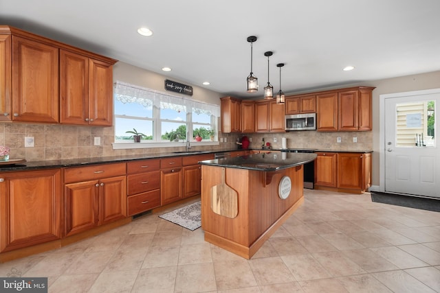 694 Ridge Rd, Telford, PA 18969 - kitchen featuring stainless steel microwave, brown cabinetry, plenty of natural light, a center island, and recessed lighting