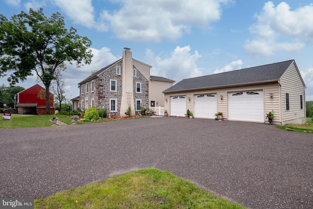 694 Ridge Rd, Telford, PA 18969 - view of front of house featuring a chimney, stone siding, and an outbuilding