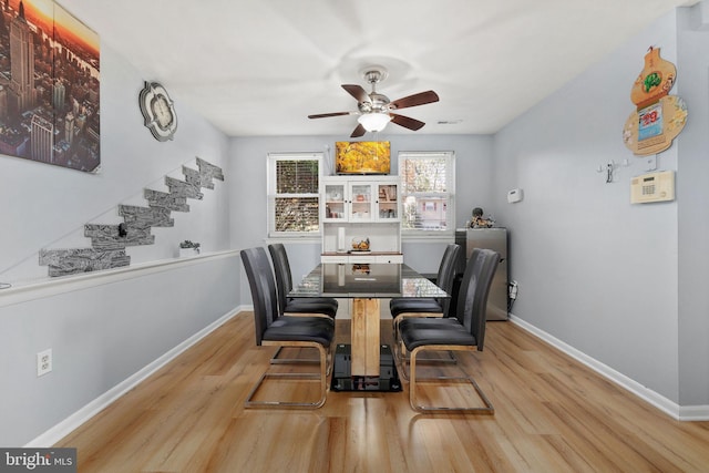 14361 Springbrook Ct, Woodbridge, VA 22193 - dining space featuring wood finished floors, a ceiling fan, and stairs