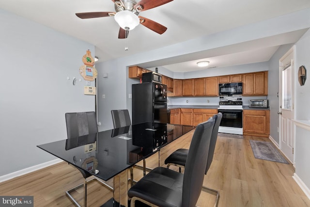 14361 Springbrook Ct, Woodbridge, VA 22193 - kitchen featuring black appliances, light wood-type flooring, brown cabinetry, and a ceiling fan