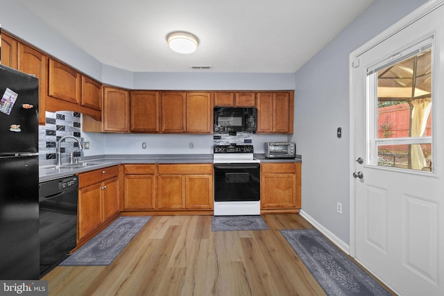 14361 Springbrook Ct, Woodbridge, VA 22193 - kitchen featuring black appliances, light wood-style floors, and brown cabinets