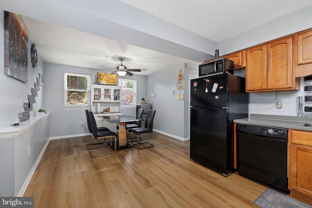 14361 Springbrook Ct, Woodbridge, VA 22193 - kitchen featuring black appliances, light wood-type flooring, ceiling fan, and brown cabinets