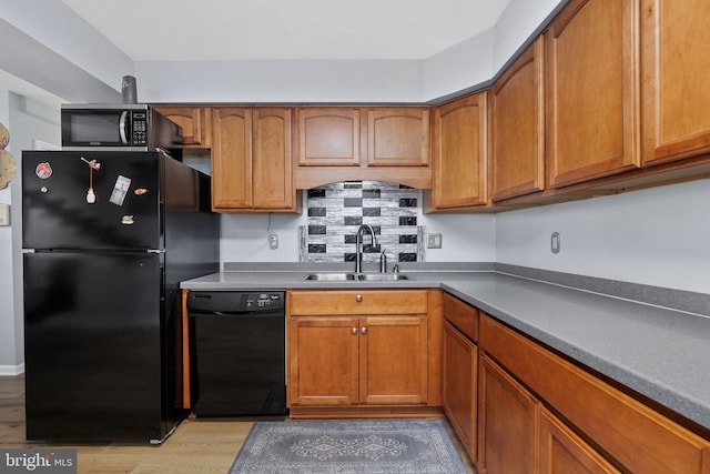 14361 Springbrook Ct, Woodbridge, VA 22193 - kitchen with black appliances, light wood finished floors, and brown cabinets