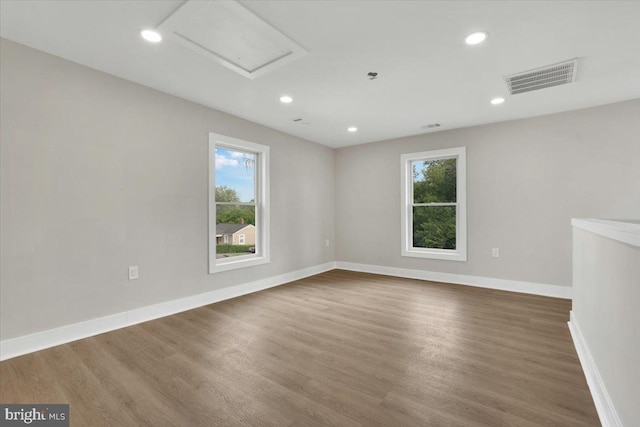 9204 Douglas St, Manassas, VA 20110 - spare room with healthy amount of natural light, wood finished floors, recessed lighting, and attic access