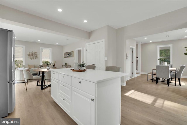 9204 Douglas St, Manassas, VA 20110 - kitchen with freestanding refrigerator, light wood finished floors, a kitchen island, plenty of natural light, and recessed lighting