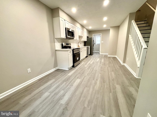 1078 Lakeview Dr, Cross Junction, VA 22625 - kitchen with appliances with stainless steel finishes, light wood-style floors, white cabinetry, tasteful backsplash, and recessed lighting