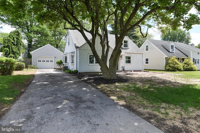 106 N Warminster Rd, Hatboro, PA 19040 - view of front of home with driveway, an outdoor structure, a detached garage, and roof with shingles