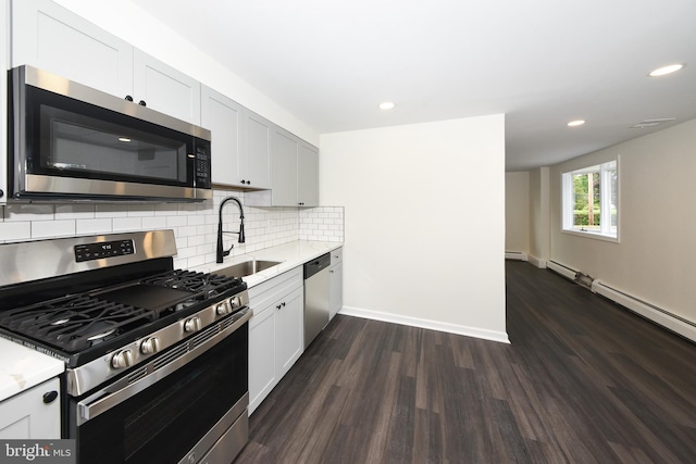 106 N Warminster Rd, Hatboro, PA 19040 - kitchen featuring appliances with stainless steel finishes, dark wood finished floors, tasteful backsplash, recessed lighting, and a baseboard radiator