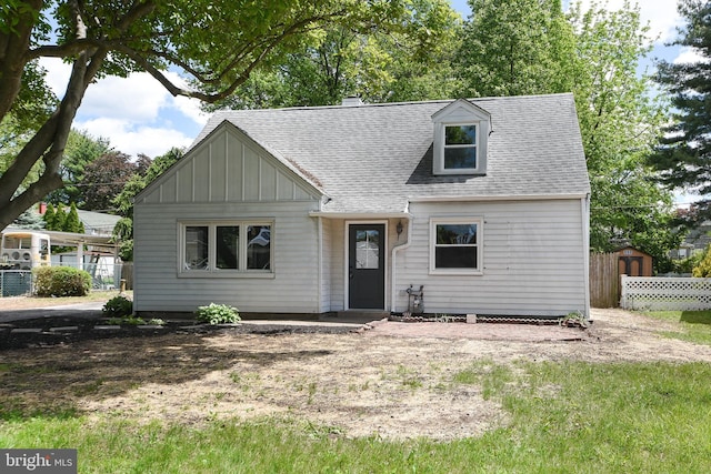 106 N Warminster Rd, Hatboro, PA 19040 - view of front facade with roof with shingles, a storage shed, board and batten siding, and a chimney