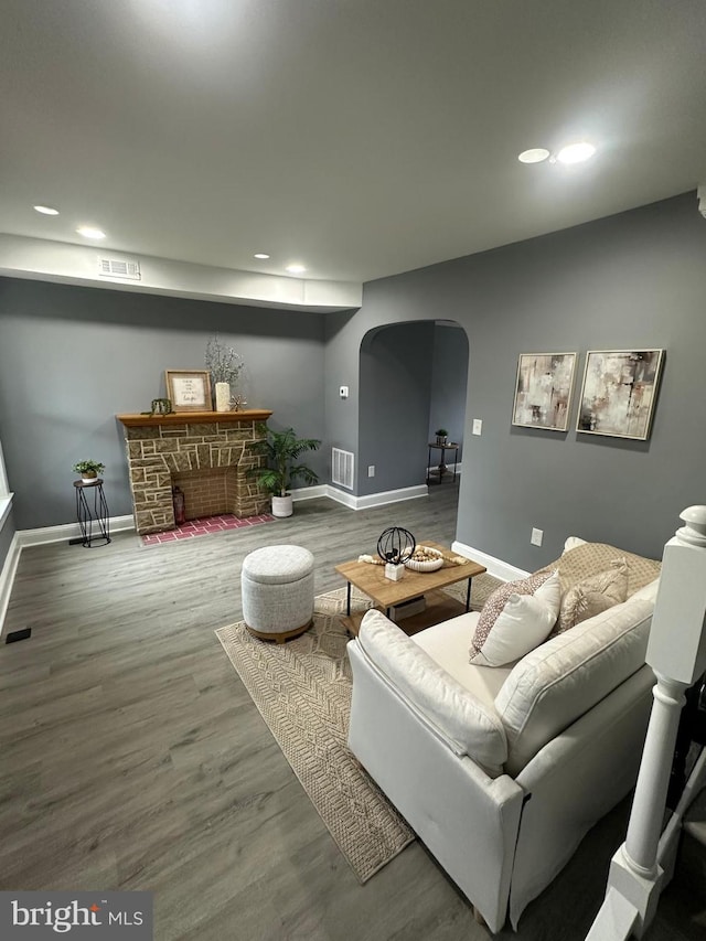 3720 Brooklyn, Baltimore, MD 21225 - living area featuring arched walkways, wood finished floors, recessed lighting, and a fireplace
